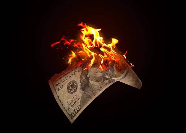 One hundred dollar banknote burning on black background