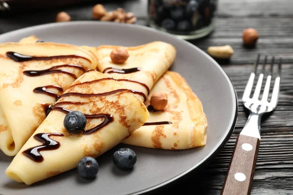 Delicious Thin Pancakes Chocolate Blueberries Nuts Black Wooden Table Closeup — Stock Photo, Image