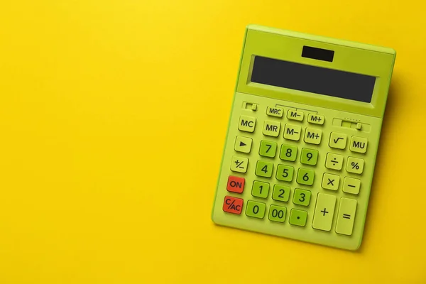 Green Calculator Yellow Background Top View Space Text — Stok fotoğraf