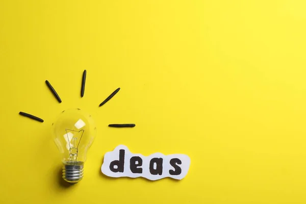 Word Ideas Made Lightbulb Paper Sheet Yellow Background Flat Lay — Foto de Stock