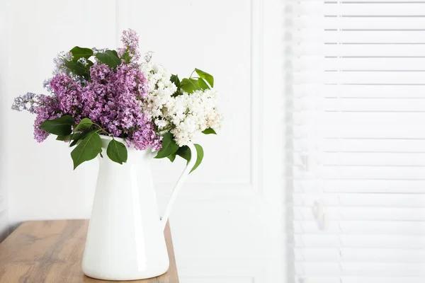 Beautiful Lilac Flowers Vase Wooden Table White Wall Space Text — стоковое фото