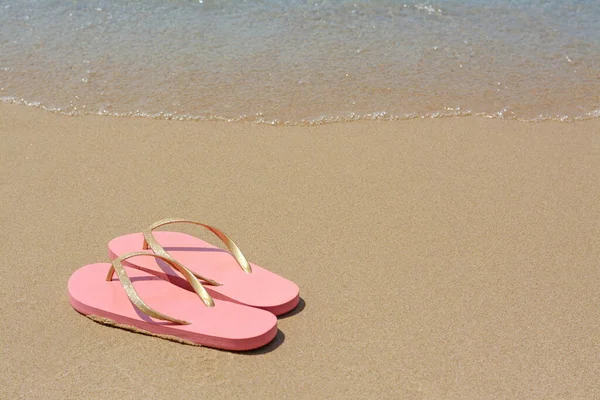 Stylish Pink Flip Flops Wet Sand Sea Space Text — Stock Photo, Image