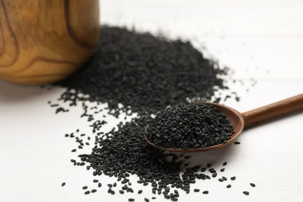 Spoon Black Sesame Seeds White Wooden Table Closeup — Stockfoto