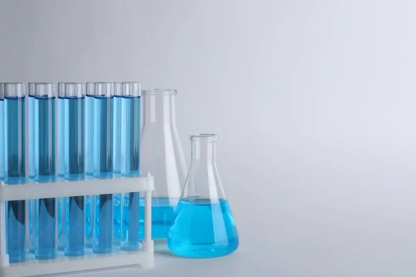 Laboratory Glassware Blue Liquid Light Grey Background Space Text — Stockfoto