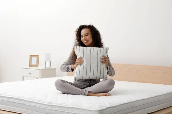 Happy Young African American Woman Hugging Pillow Bed Comfortable Mattress — стоковое фото