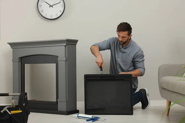 Man Screwdriver Installing Electric Fireplace Wall Room — Foto de Stock