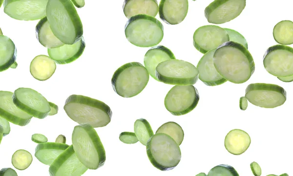 Slices Fresh Green Cucumbers Falling White Background — Φωτογραφία Αρχείου