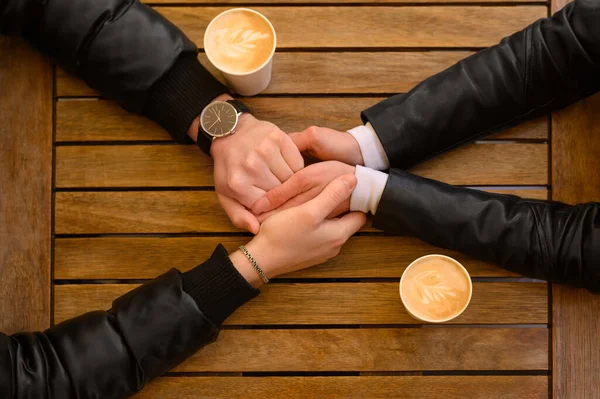 Lovely Couple Coffee Holding Hands Together Wooden Table Top View —  Fotos de Stock