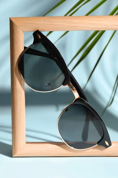Stylish Sunglasses Photo Frame Light Blue Background — Stockfoto
