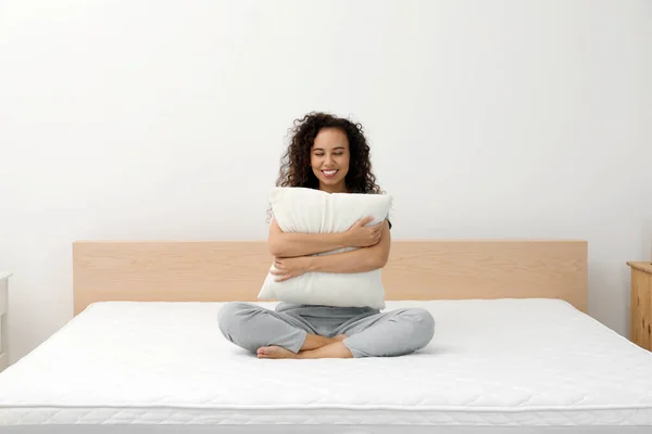 Happy Young African American Woman Hugging Pillow Bed Comfortable Mattress — стоковое фото