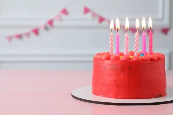 맛있는 크림을 곁들인 케이크에 분홍색 위에서 촛불을 태운다 원문을 — 스톡 사진