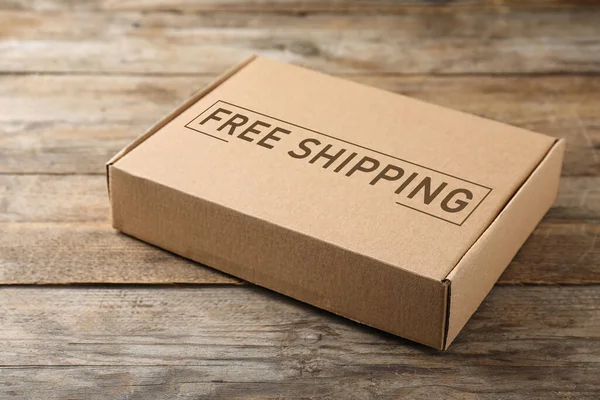 One Closed Cardboard Box Wooden Table Free Shipping — Fotografia de Stock