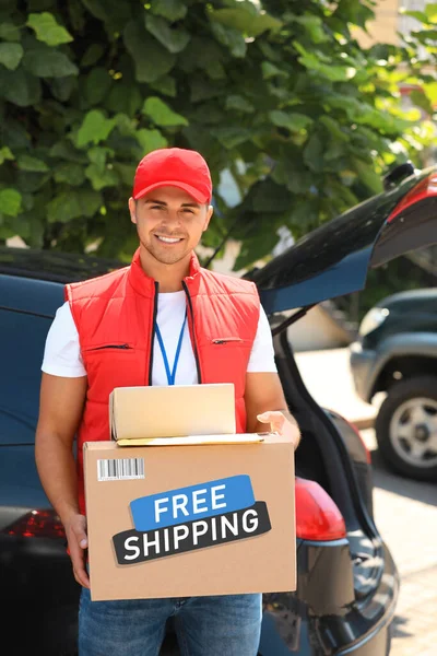 Young Courier Holding Parcels Car Outdoors Free Shipping — Fotografia de Stock