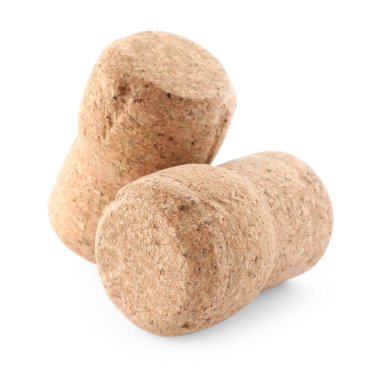 Beyaz arka planda iki köpüklü şarap mantarı.