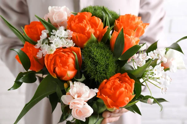 Woman with bouquet of beautiful orange peony tulips, closeup