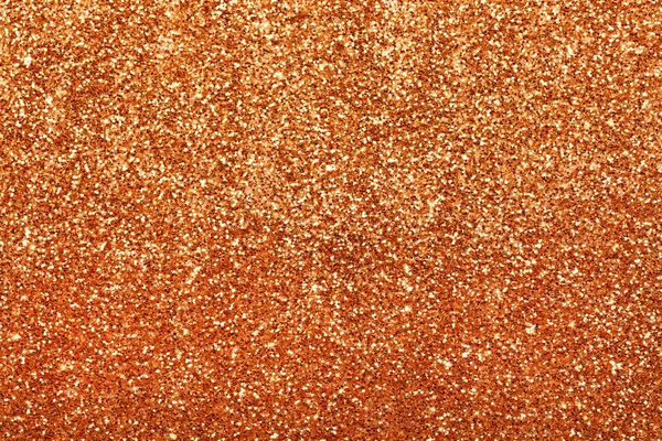 Beautiful shiny orange glitter as background, closeup