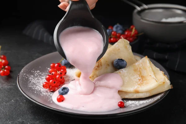 Woman Pouring Natural Yogurt Crepes Blueberries Red Currants Table Closeup — Photo