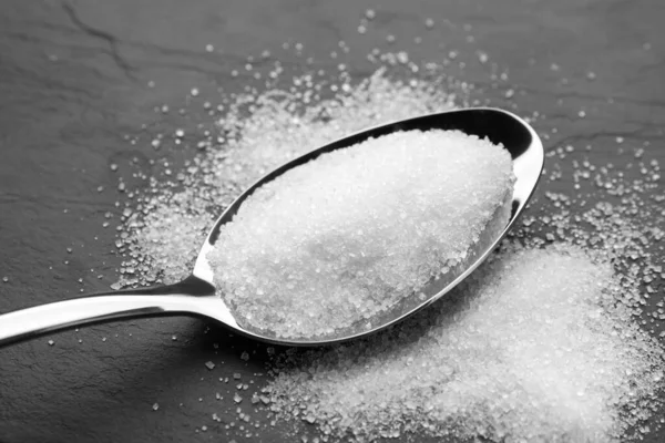 Granulated Sugar Spoon Black Table Closeup —  Fotos de Stock