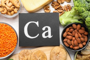 Beyaz ahşap masada yüksek kalsiyum içeren doğal besin seti.