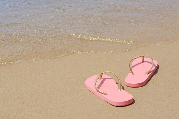 Stylish Pink Flip Flops Wet Sand Sea Space Text — Stockfoto