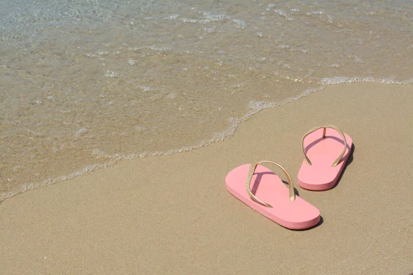 Stylish Pink Flip Flops Wet Sand Sea Space Text — 图库照片