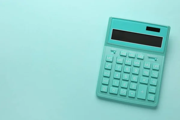 Turquoise Calculator Light Blue Background Top View Space Text — Stok fotoğraf