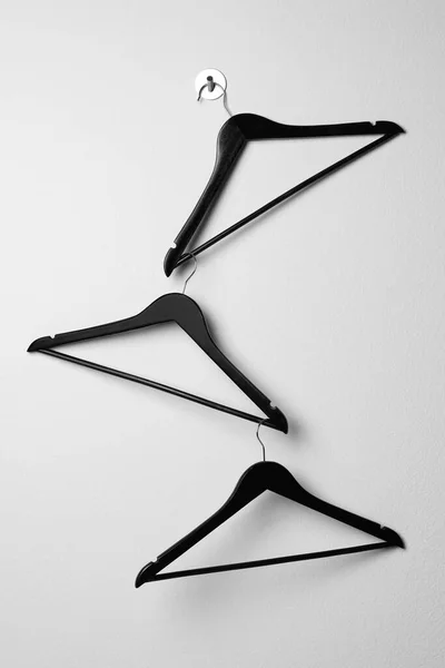 Empty Black Clothes Hangers White Wall — стоковое фото