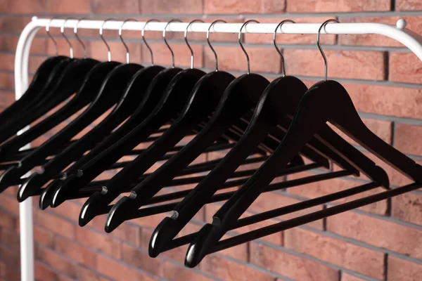 Black Clothes Hangers Rack Red Brick Wall — Stockfoto