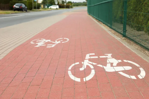 Red Bicycle Lane White Signs Pavement Road —  Fotos de Stock