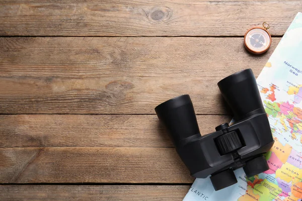 Modern Binoculars Map Compass Wooden Table Flat Lay Space Text — Stock Photo, Image