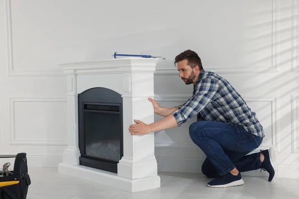 Man Installing Electric Fireplace White Wall Room — Foto de Stock