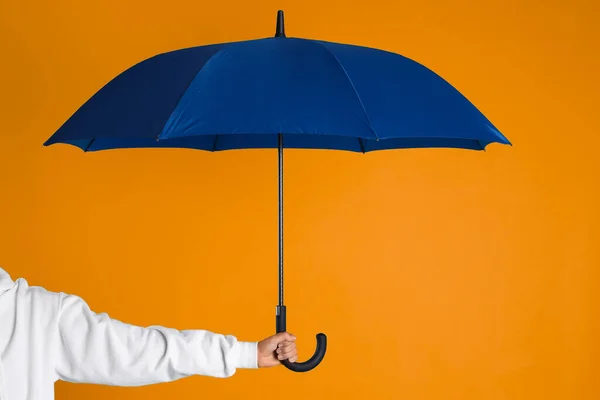 Woman Open Blue Umbrella Orange Background Closeup — стоковое фото