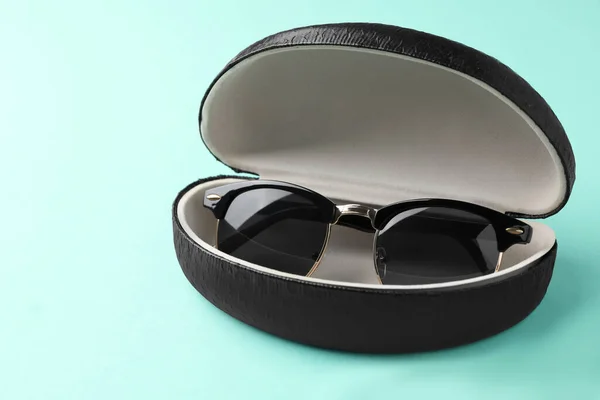 Stylish Sunglasses Black Leather Case Light Blue Background — Φωτογραφία Αρχείου