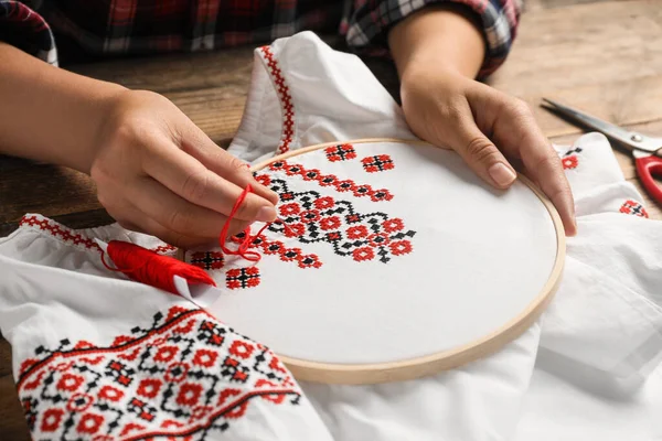 Woman Embroidering White Shirt Colorful Threads Wooden Table Closeup Ukrainian — Fotografia de Stock