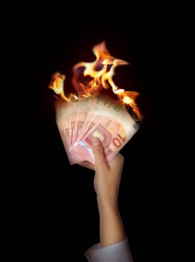 Woman holding burning euro banknotes on black background, closeup