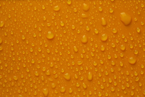 Many Water Drops Bright Orange Background — Stock fotografie
