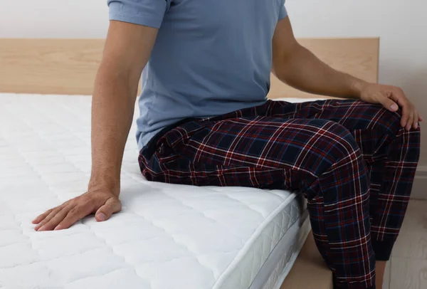 Man Sitting Bed Comfortable Mattress Home Closeup — Stockfoto