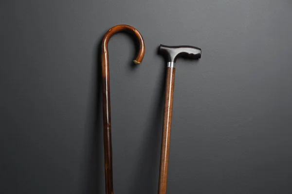 Different Wooden Walking Canes Grey Background — Stock Fotó