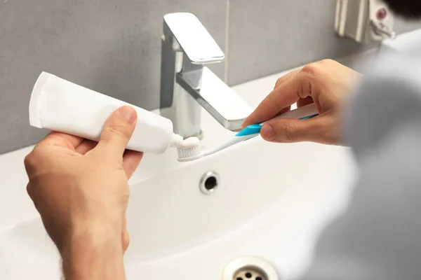 Man Applying Toothpaste Brush Sink Bathroom Closeup —  Fotos de Stock