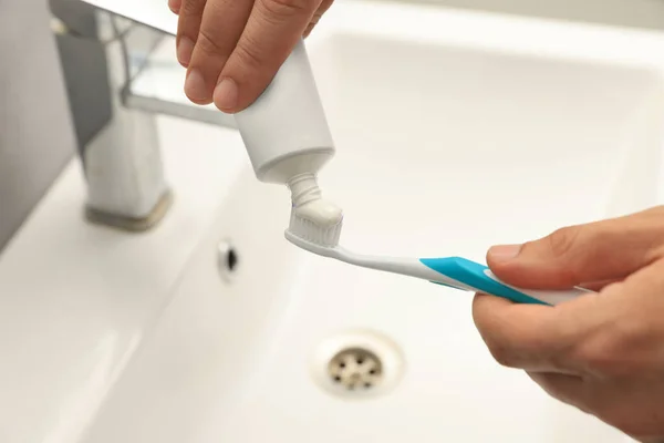 Man Applying Toothpaste Brush Sink Bathroom Closeup — Stockfoto