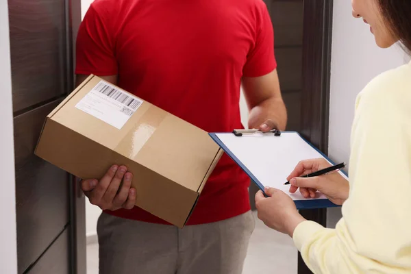 Woman Signing Delivered Parcel Home Closeup — 스톡 사진