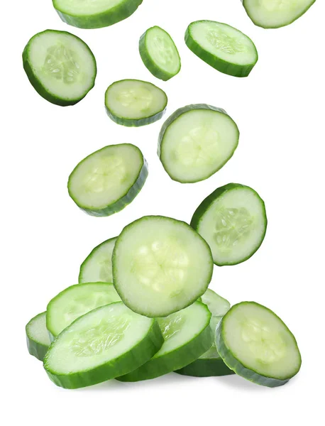 Slices Fresh Green Cucumbers Falling White Background — стоковое фото