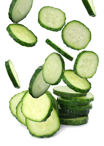 Slices Fresh Green Cucumbers Falling White Background — стоковое фото