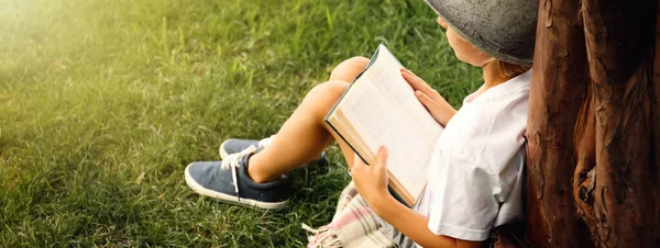 Cute Little Boy Reading Book Green Grass Tree Park Space — Foto de Stock