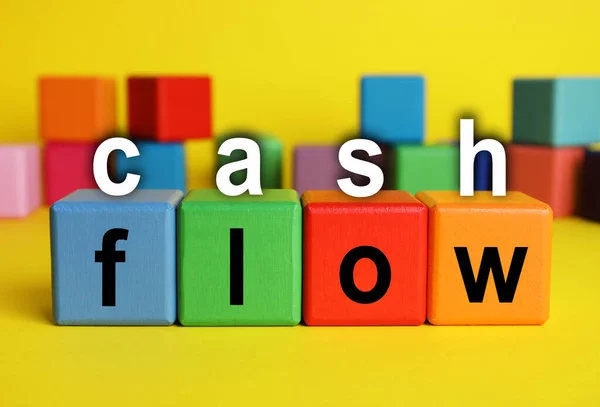 Phrase Cash Flow Made Letters Colorful Cubes Yellow Background — Stockfoto