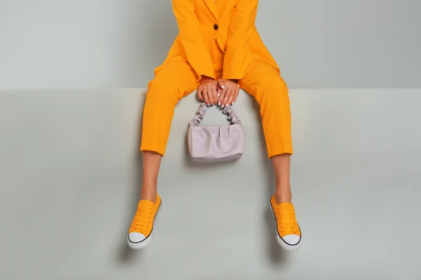 Young Woman Wearing Stylish Orange Clothes Bag Grey Background Closeup — Φωτογραφία Αρχείου