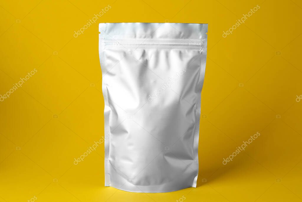 One blank foil package on yellow background