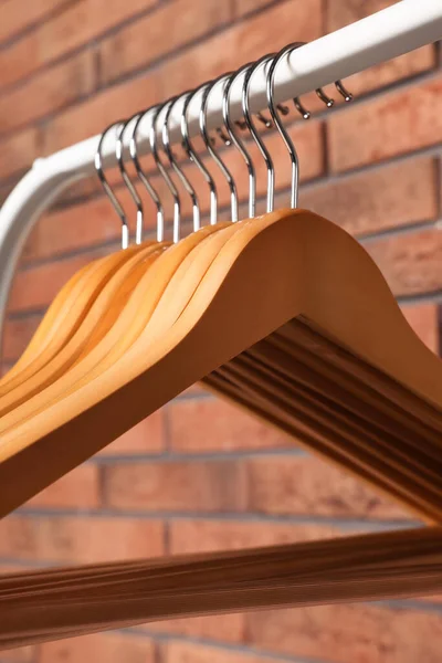 Wooden Clothes Hangers Rack Red Brick Wall Closeup — 스톡 사진