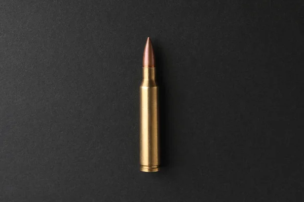 One Bullet Black Background Top View — Stockfoto