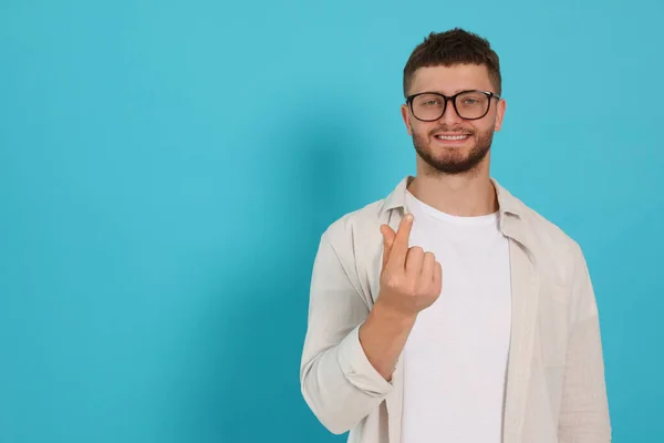 Young Man Showing Heart Gesture Light Blue Background Space Text — Stock fotografie